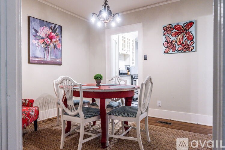 A dining room with a table and chairs.