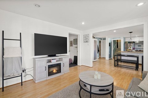 A modern living room with a television and a fireplace.