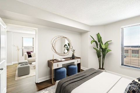 A bedroom with a bed, desk, and chair.