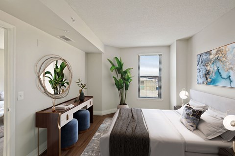 A bedroom with a large bed, a mirror, and a painting on the wall.