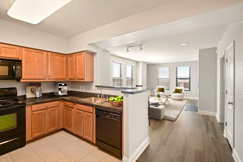 A kitchen with wooden cabinets and black appliances.