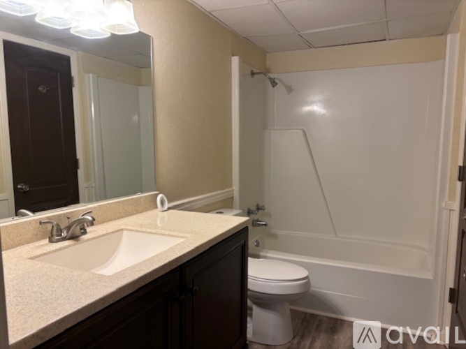 A bathroom with a sink, toilet, and bathtub.