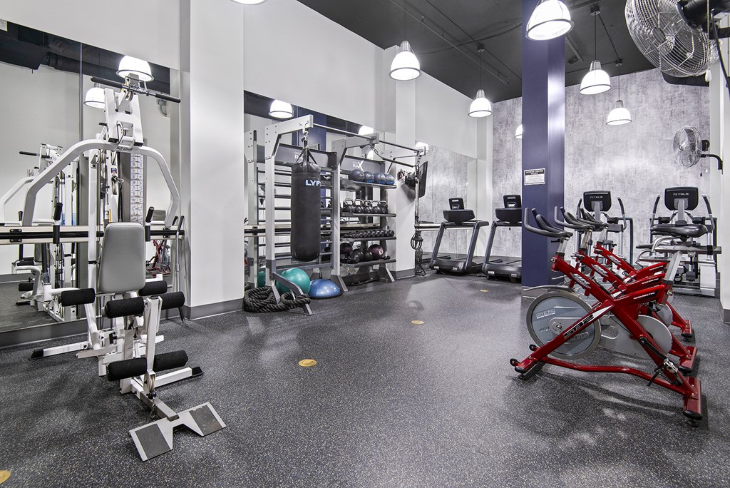 A gym with a variety of equipment including a leg press machine.