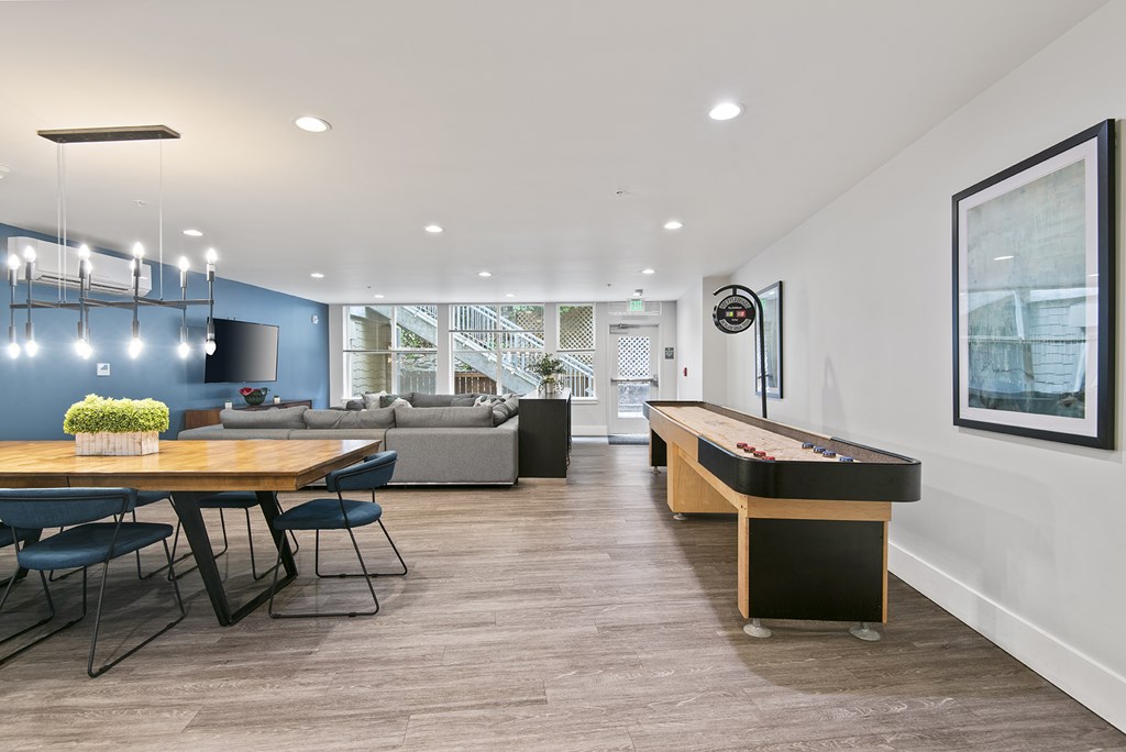 A room with a pool table and a couch.