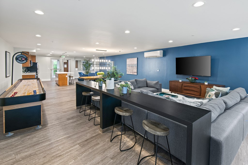 A modern living room with a pool table and bar area.