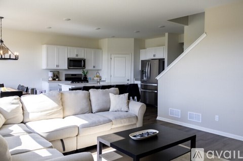 A modern living room with a white sofa and a black coffee table.
