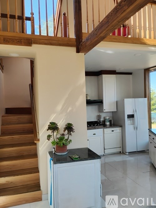 A kitchen with a refrigerator, stove, and cabinets.