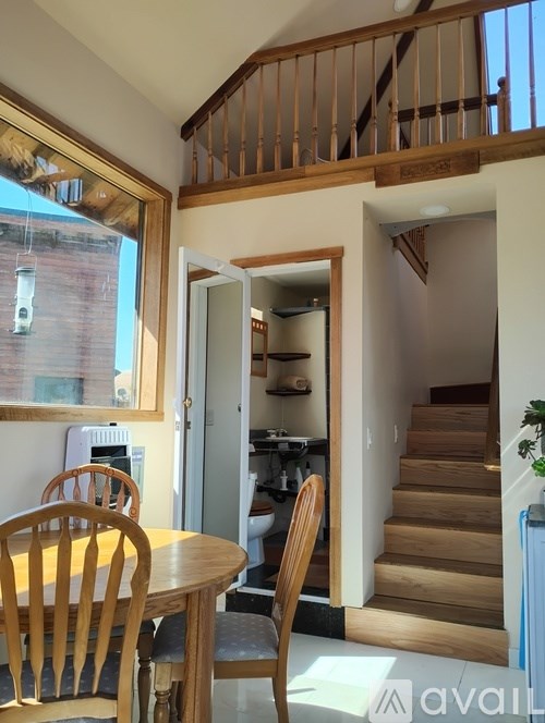 A dining room with a table and chairs is shown.