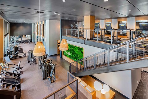 A gym with a green wall and a staircase.