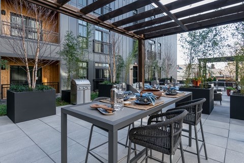 A patio with a table and chairs is set up outside a building.