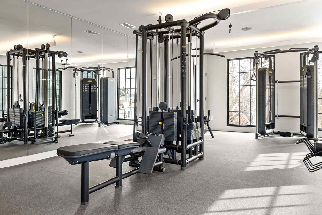 A gym with a variety of equipment including a leg press machine.