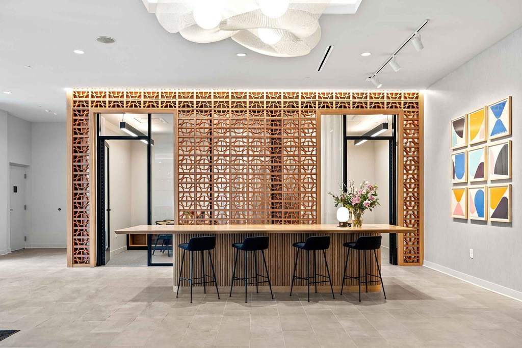 A modern dining room with a wooden partition and a white ceiling.