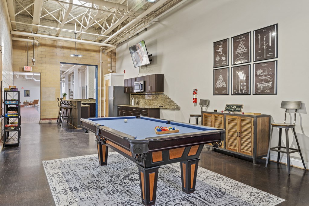 a game room with a pool table and a bar