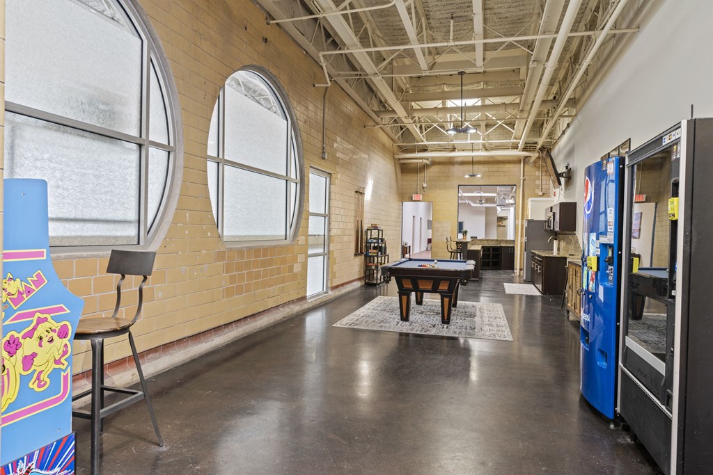 a room with a ping pong table and a large window