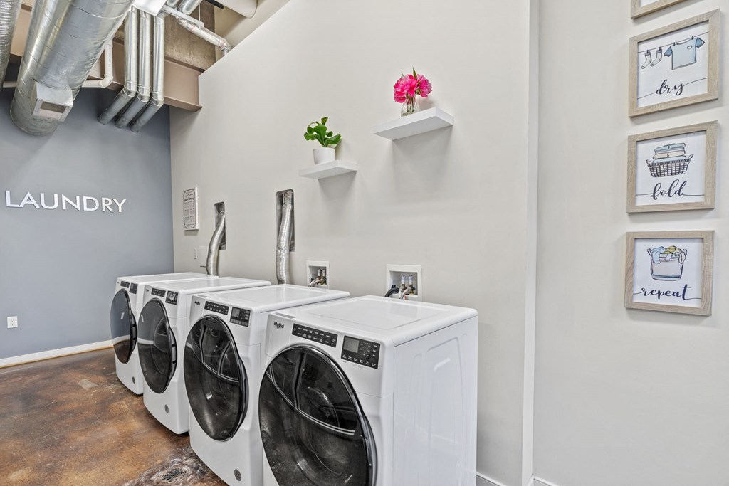 a laundry room with two washes and two dryers