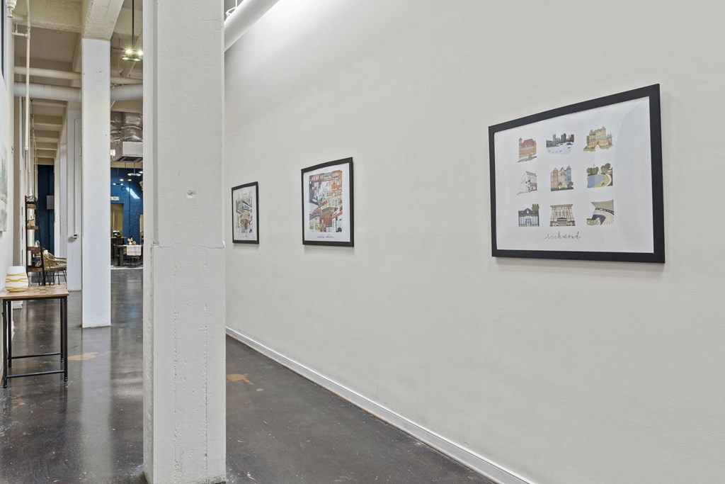 three framed pictures on a white wall in a room