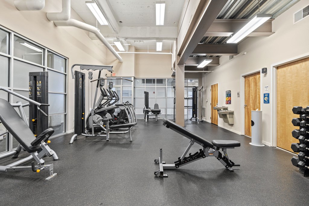a gym with weights and other exercise equipment in a building