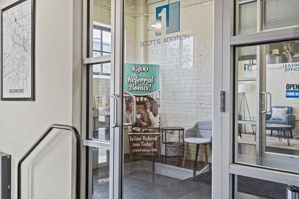 the entrance of a restaurant with a sign in the door