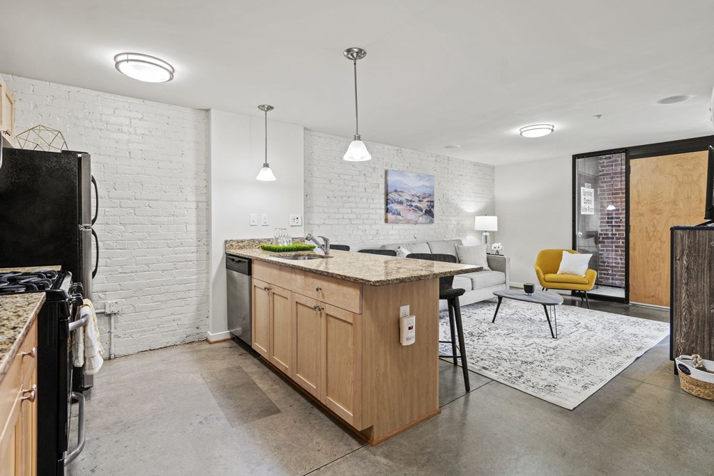 a kitchen with an island and a living room