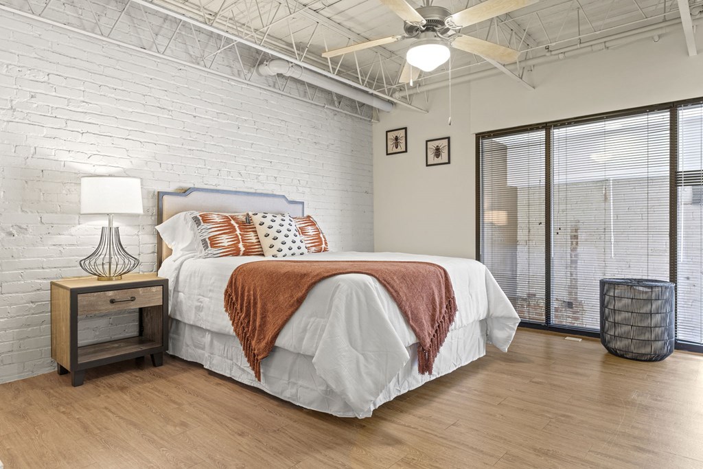a bedroom with a bed and a ceiling fan