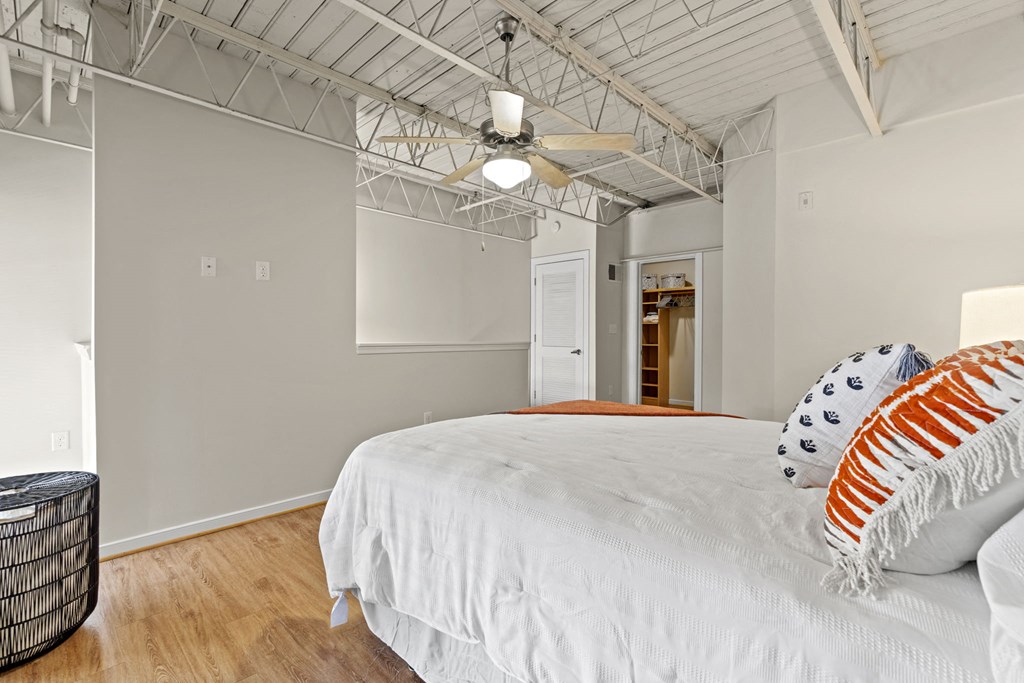 a bedroom with a large bed and a ceiling fan