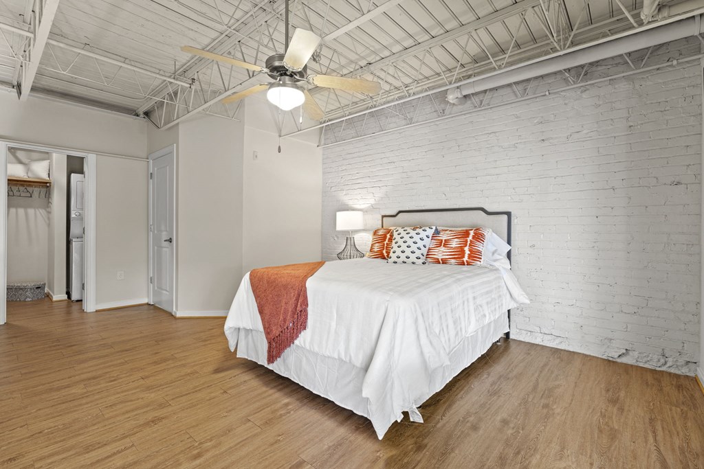 a bedroom with a bed and a ceiling fan