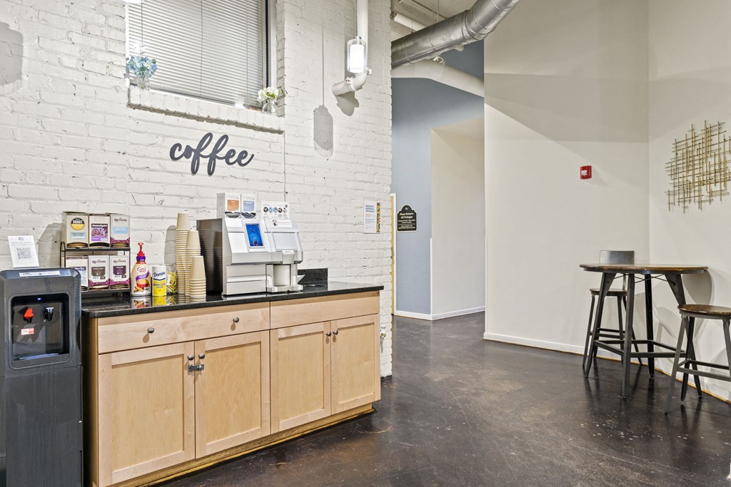 a coffee shop with a counter and a white brick wall