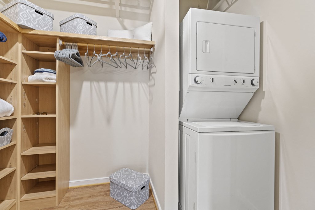 a small laundry room with a washer and dryer and a closet