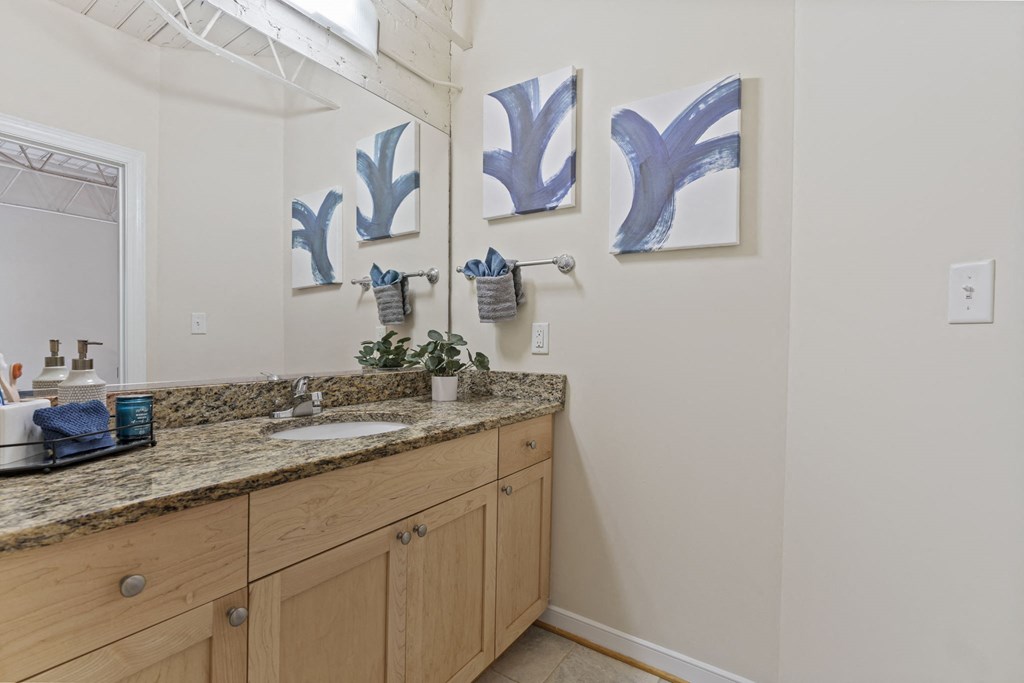 a bathroom with a granite counter top and a sink