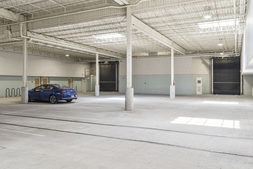 a blue car parked in a parking garage