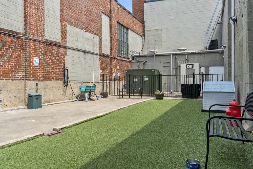 a small yard with a bench and a fire hydrant