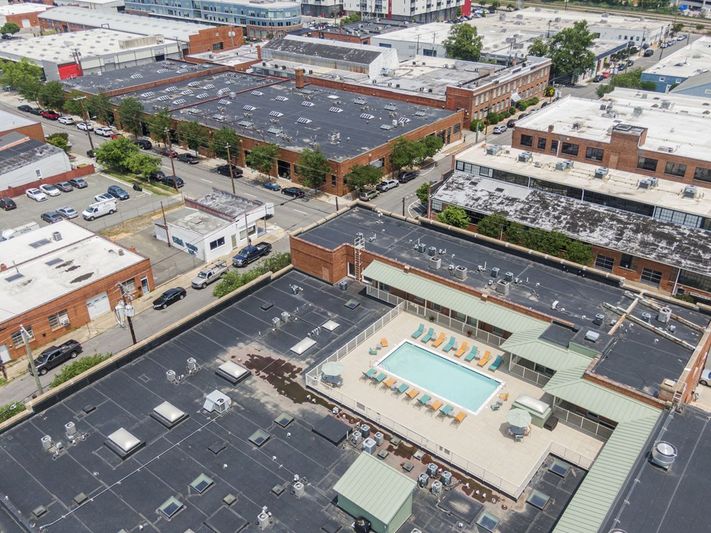 an aerial view of a parking lot and buildings in a city