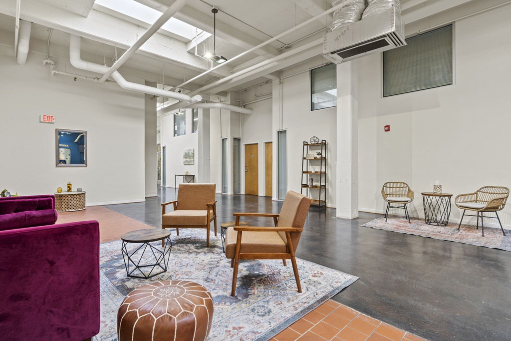 a living room with a purple couch and chairs
