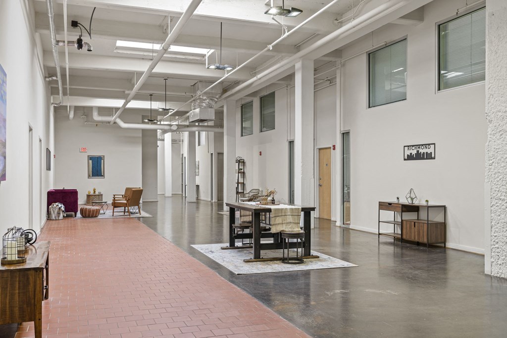 a large room with a table and chairs in the middle
