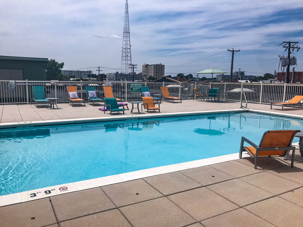 a swimming pool at a hotel with a city in the background