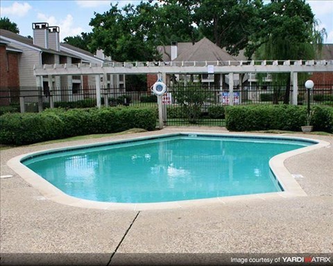 a swimming pool in front of an apartment building