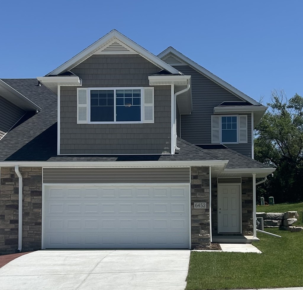 A house with a garage door numbered 6452.