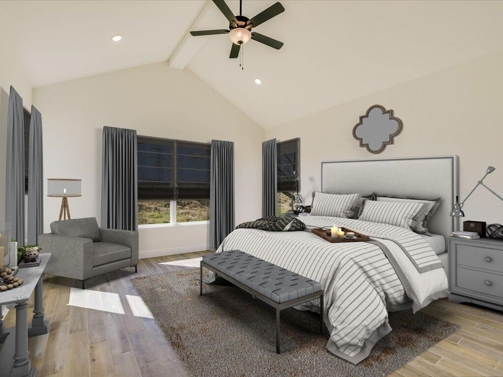 A bedroom with a large bed, a ceiling fan, and a window with curtains.
