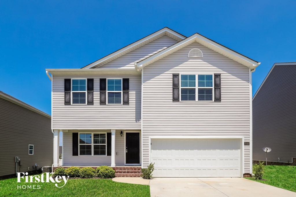 A two-story house with a garage is for sale by FirstKey Homes.
