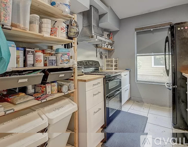 A kitchen with a lot of shelves and containers.