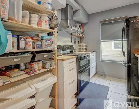 A kitchen with a lot of shelves and containers.