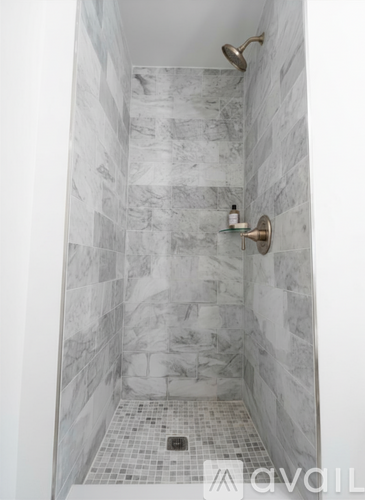 A bathroom with a toilet, sink, and cabinet.