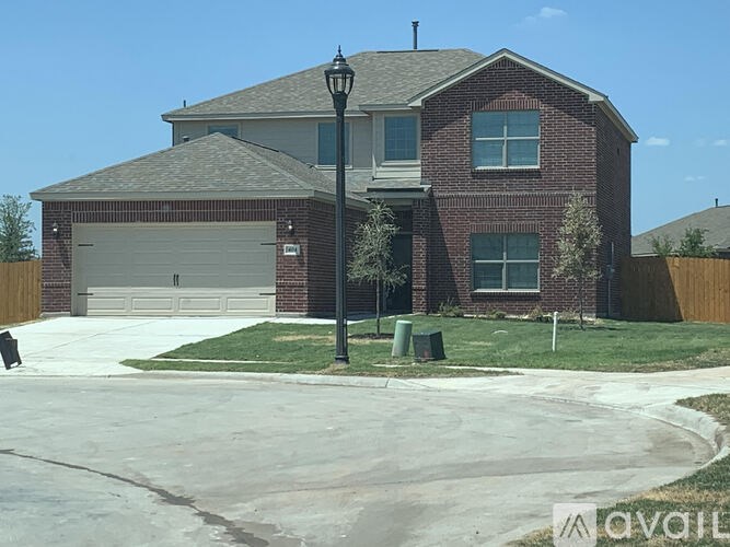A house with a brick facade and a garage door.