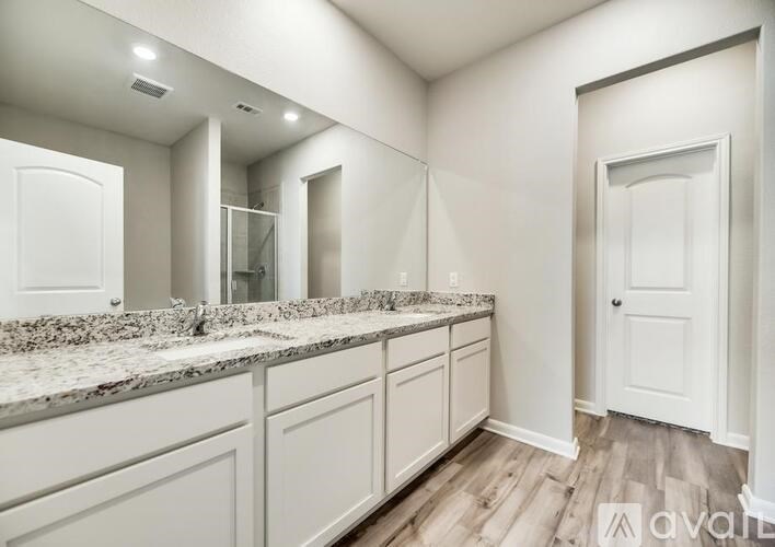 A bathroom with a vanity and a large mirror.