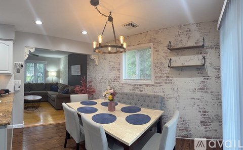 A dining room with a table set for four.