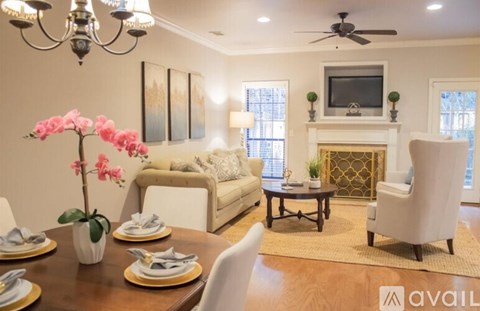 A well-lit living room with a dining table set for two.