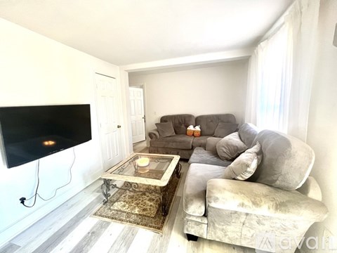 A living room with a grey couch and a coffee table.