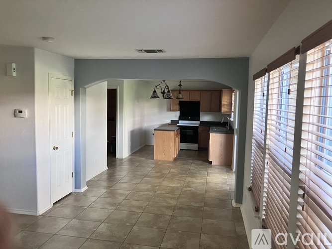 A kitchen with wooden cabinets and a black oven.