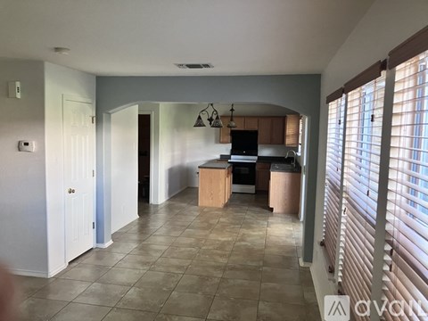 A kitchen with wooden cabinets and a black oven.