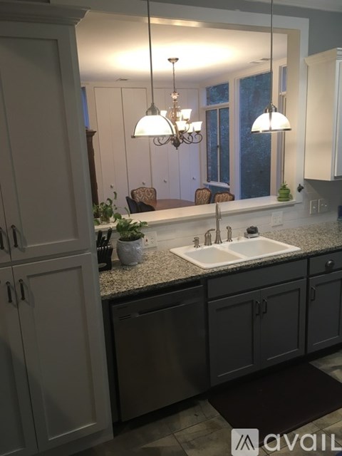 A kitchen with a sink and a mirror.